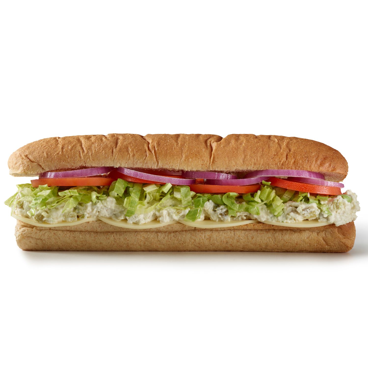Side view of a chicken salad sub with lettuce, tomato, red onion, and creamy chicken salad on a hoagie roll.