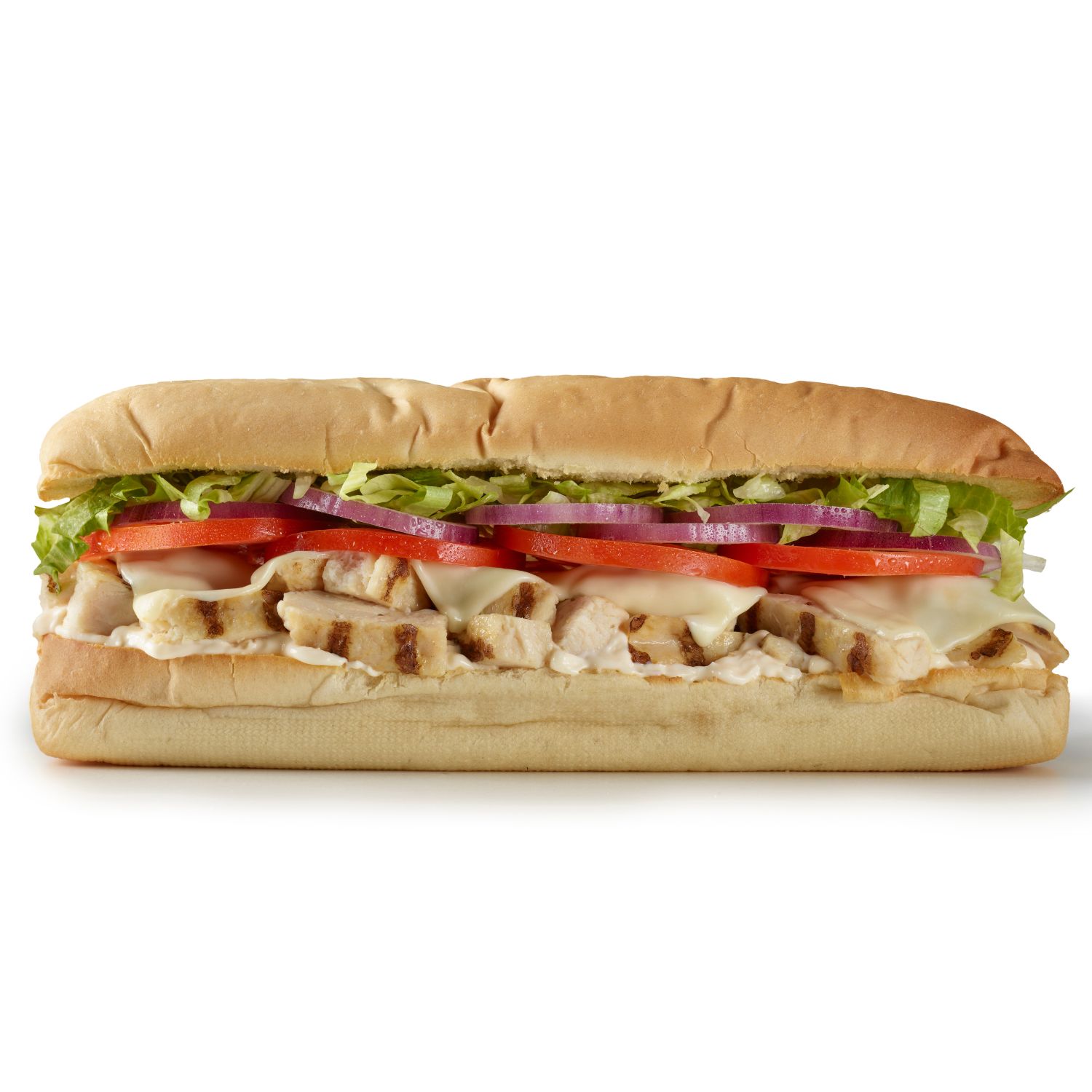 ALT Text Side view of a grilled chicken sub sandwich with sliced chicken, lettuce, tomato, red onion, cheese, and sauce on a hoagie roll.