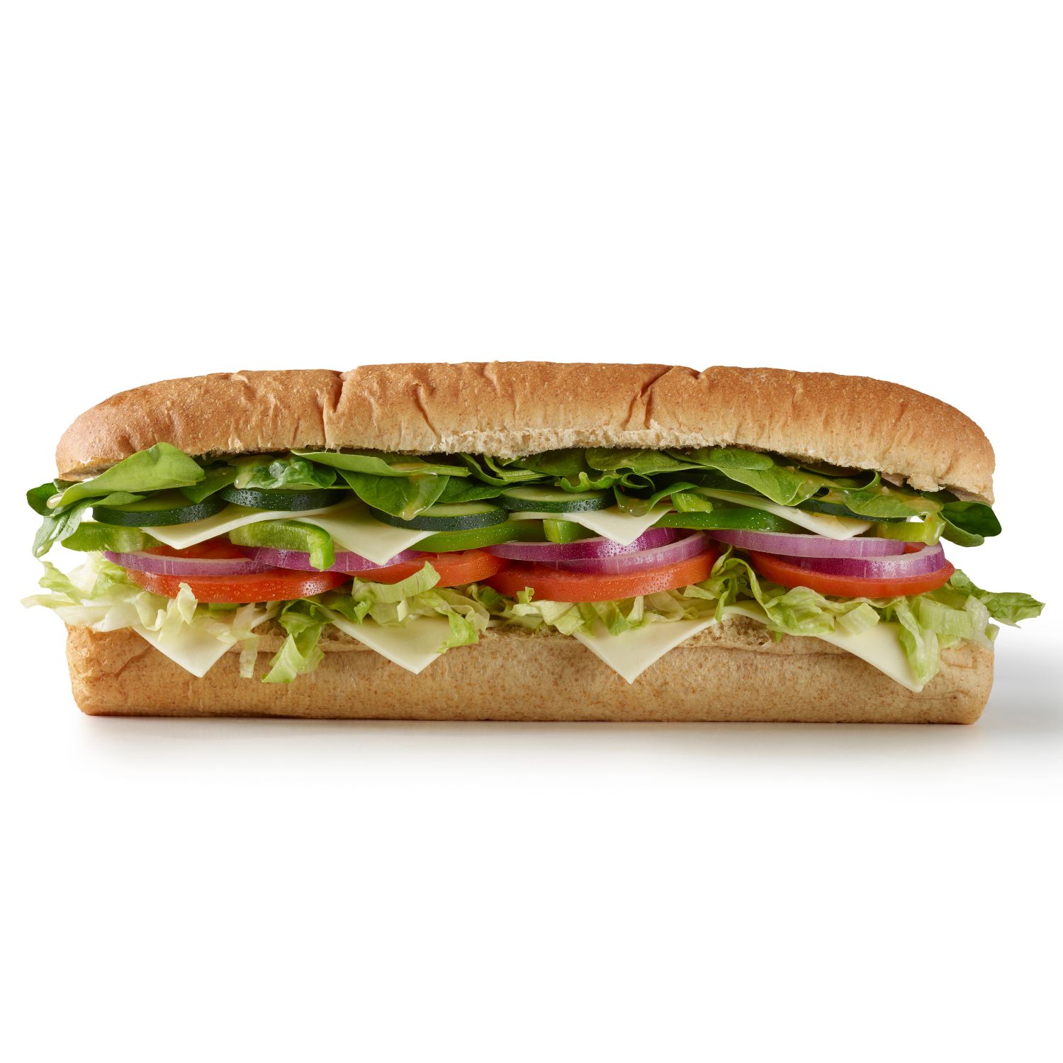 Side view of a vegetable sub sandwich with lettuce, tomato, cucumber, red onion, green bell peppers, spinach, and cheese on whole wheat bread.